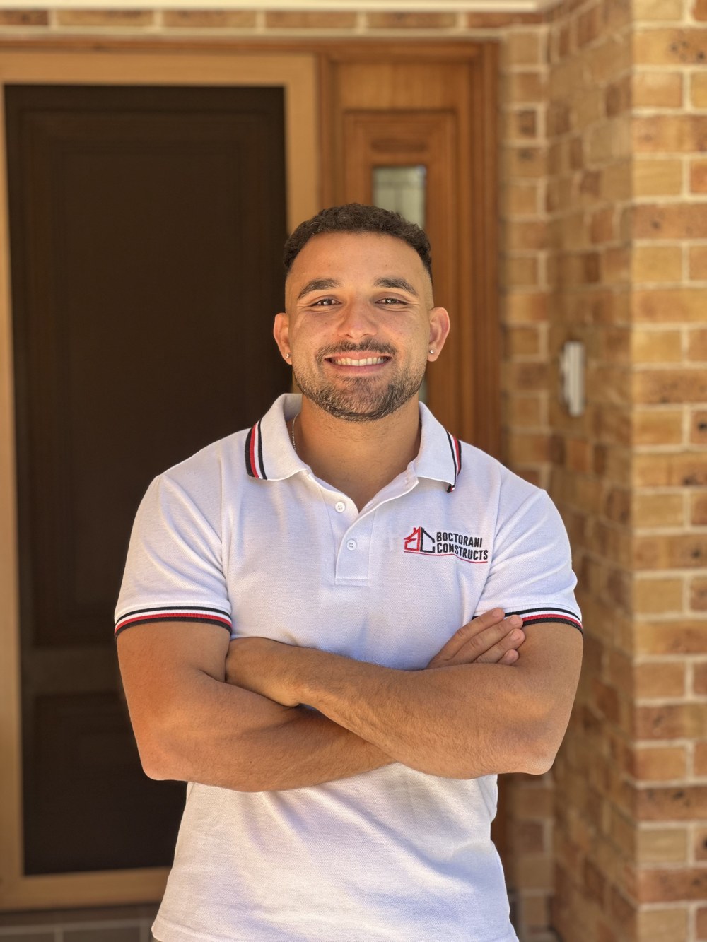 Daniel Boctorani, Managing Director of Boctorani Constructs, smiling with his arms crossed