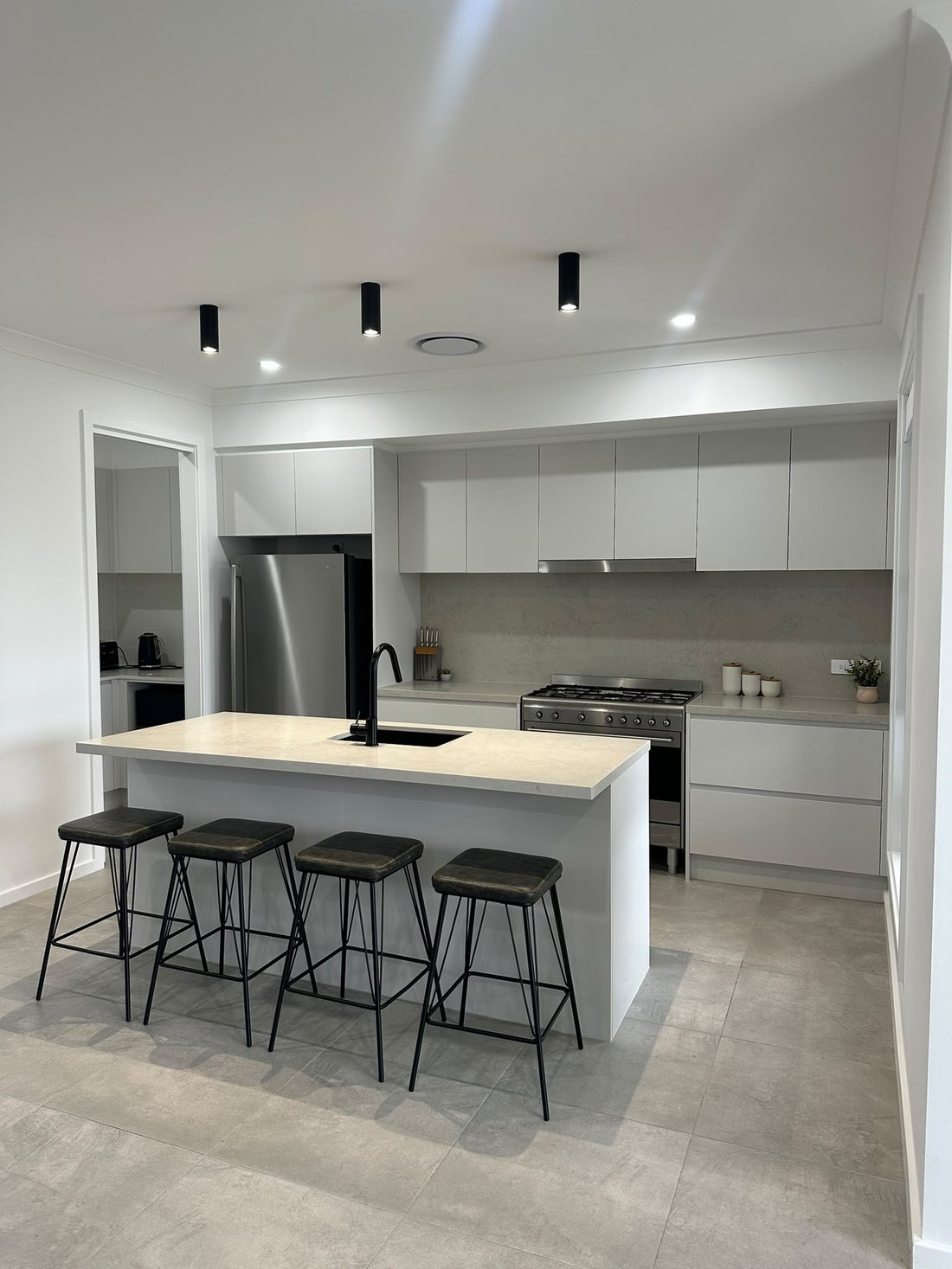Peakhurst kitchen with a large island bench, gas cooktop and timber overhead cabinets