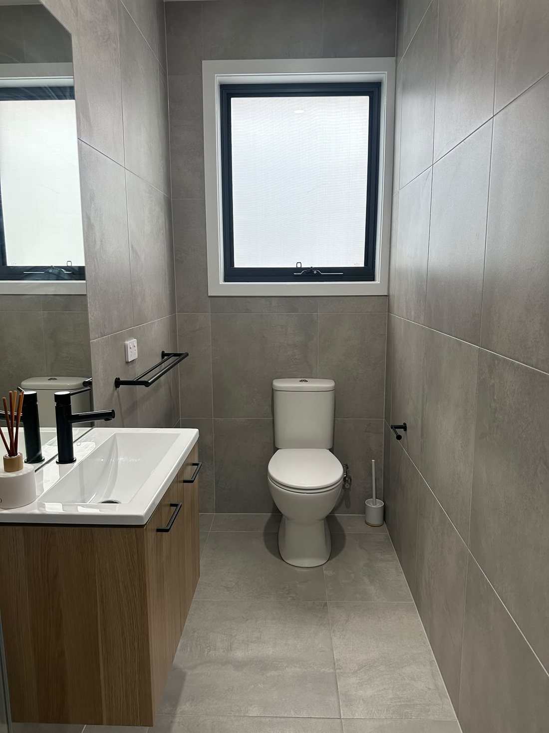 Peakhurst powder room with a timber vanity, white basin and frosted window